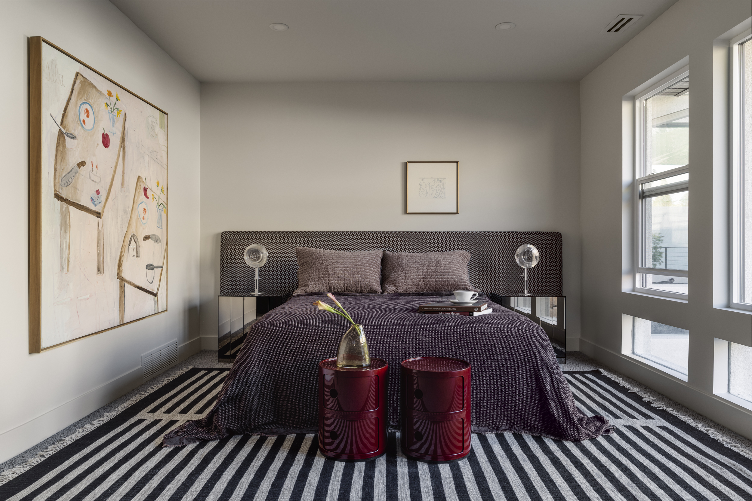Quiet bedroom with tailored furnishings and artwork