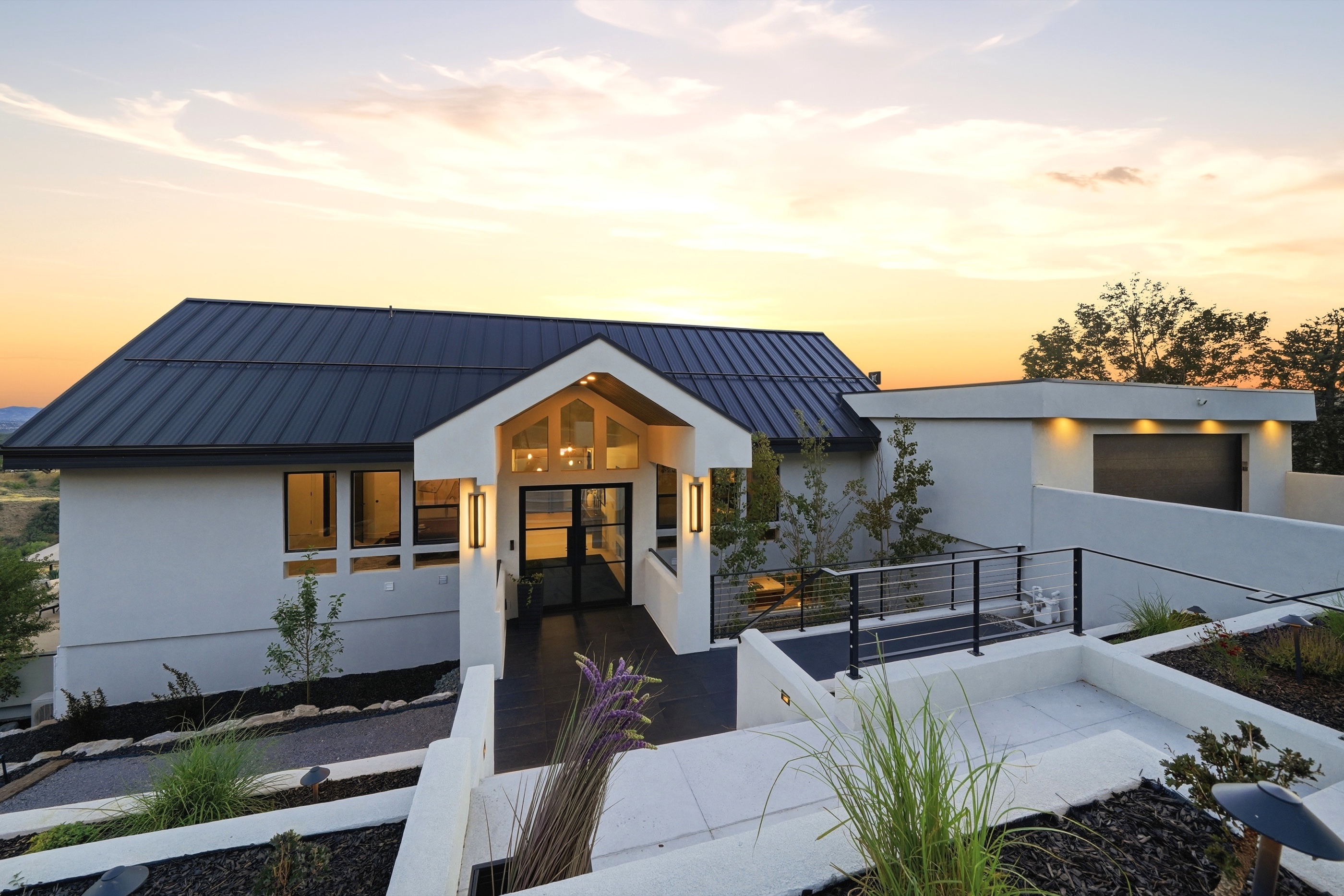 Front exterior and landscaped entry at twilight