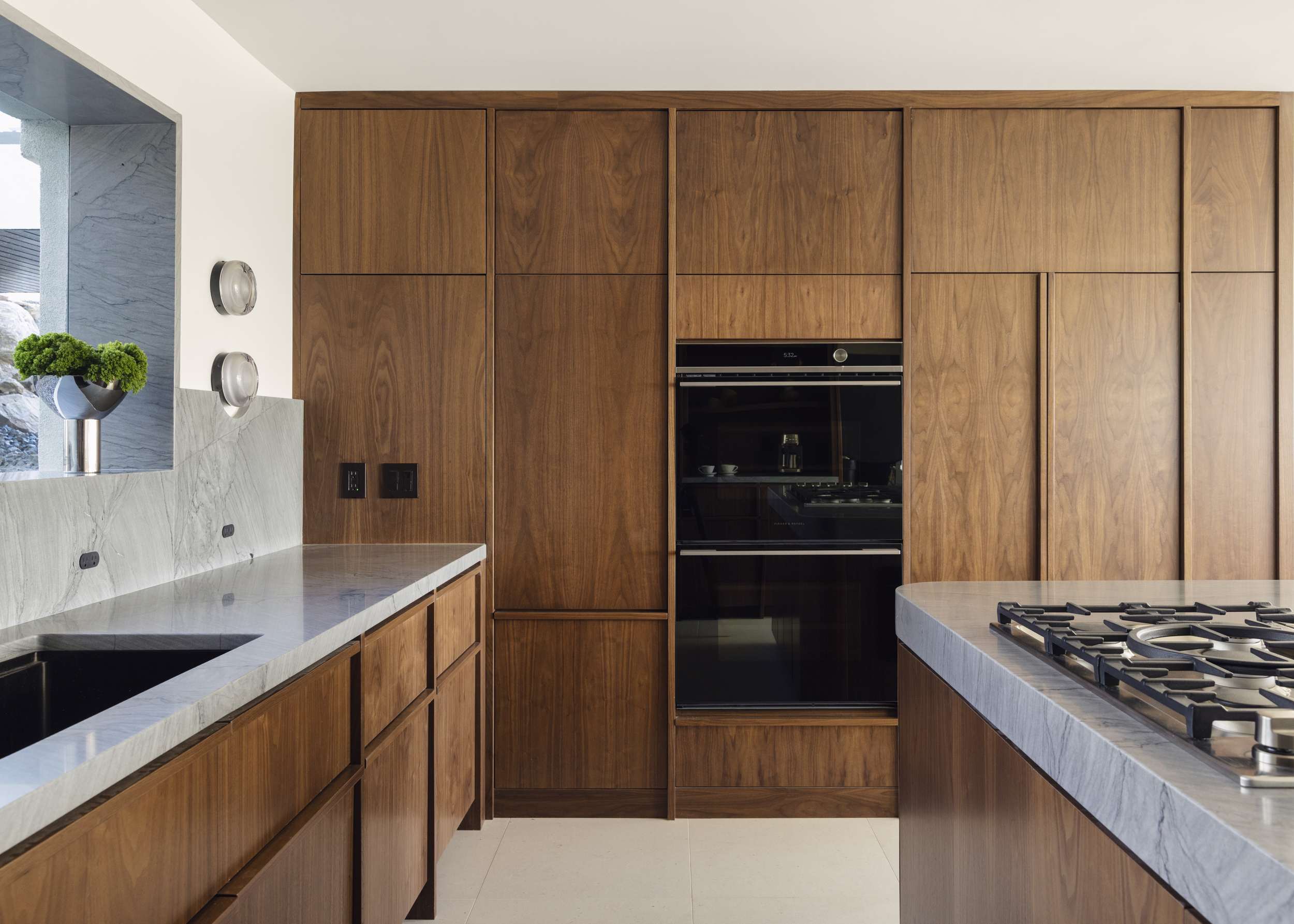 Walnut kitchen cabinetry with integrated appliances