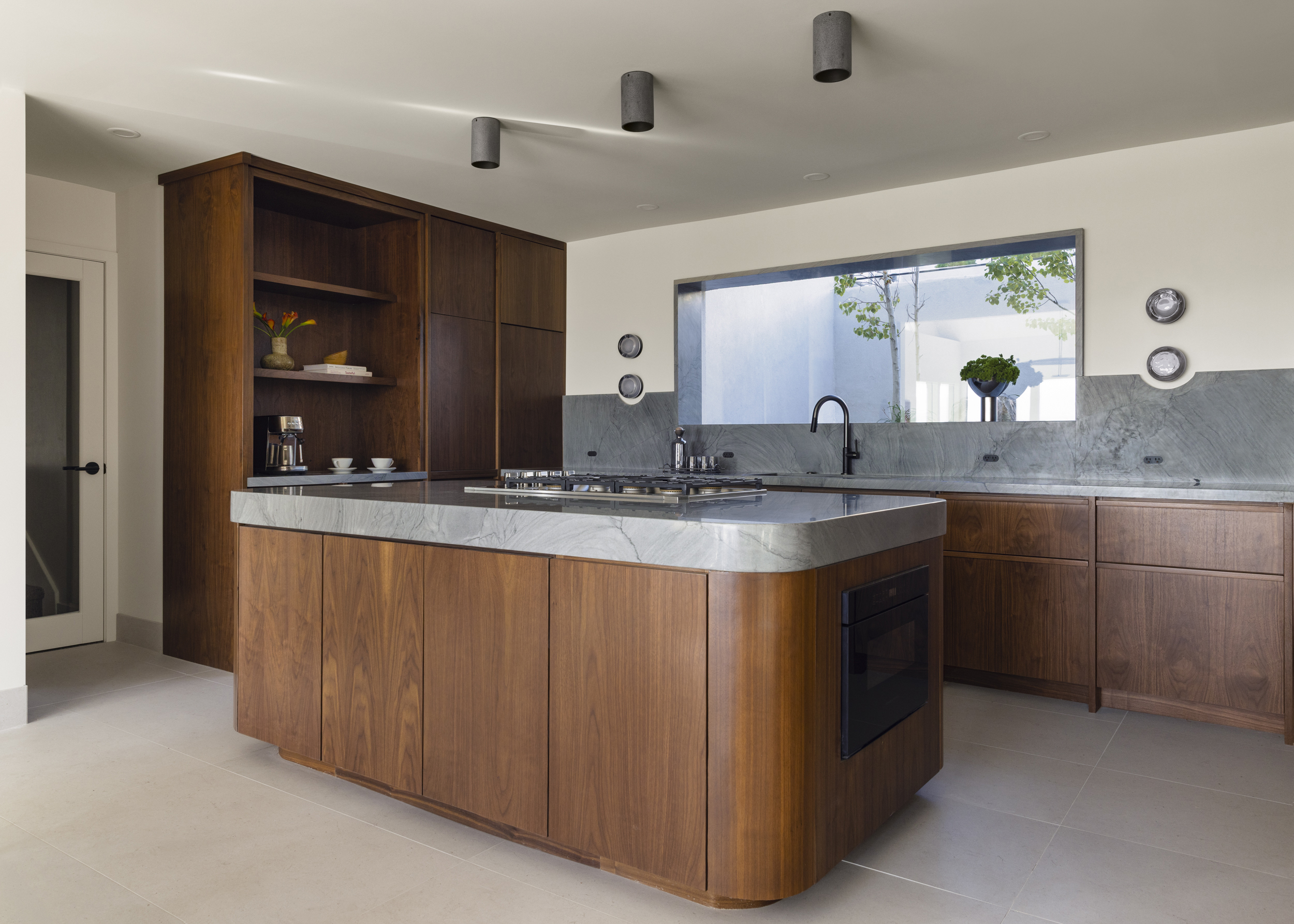 Walnut kitchen with quartzite island and backsplash