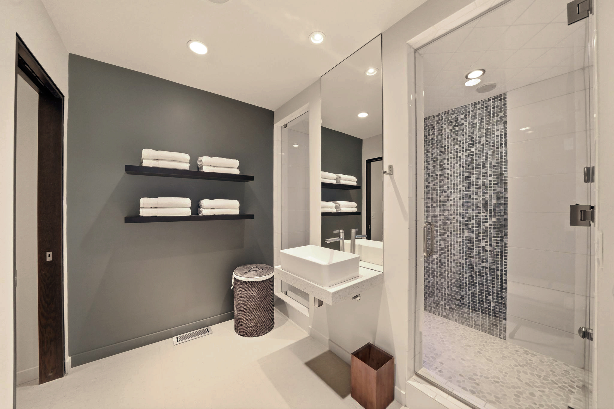 Steam shower with mosaic tile, vanity and built-in towel shelves