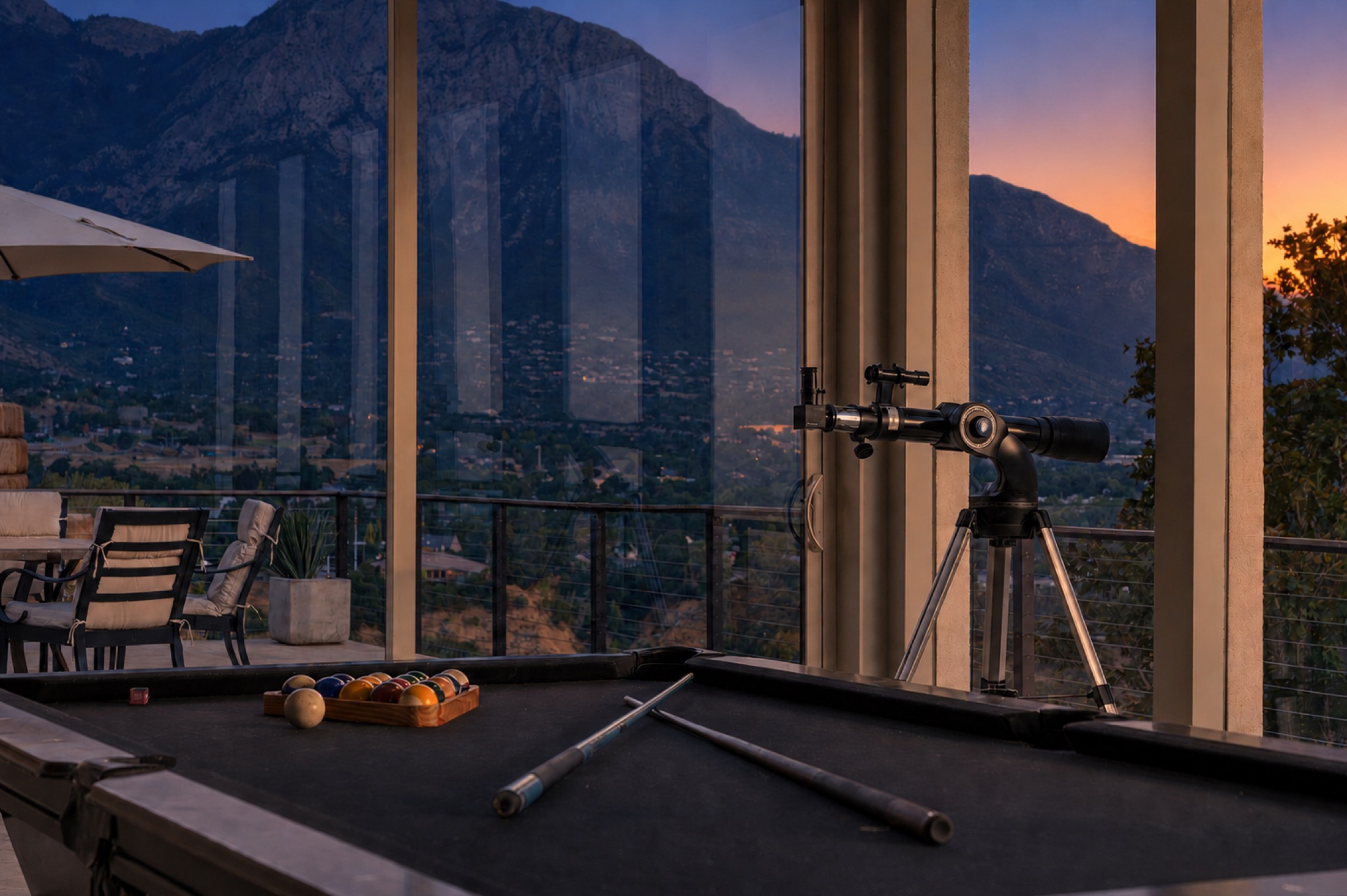 Mountain view through windows near a billiards table