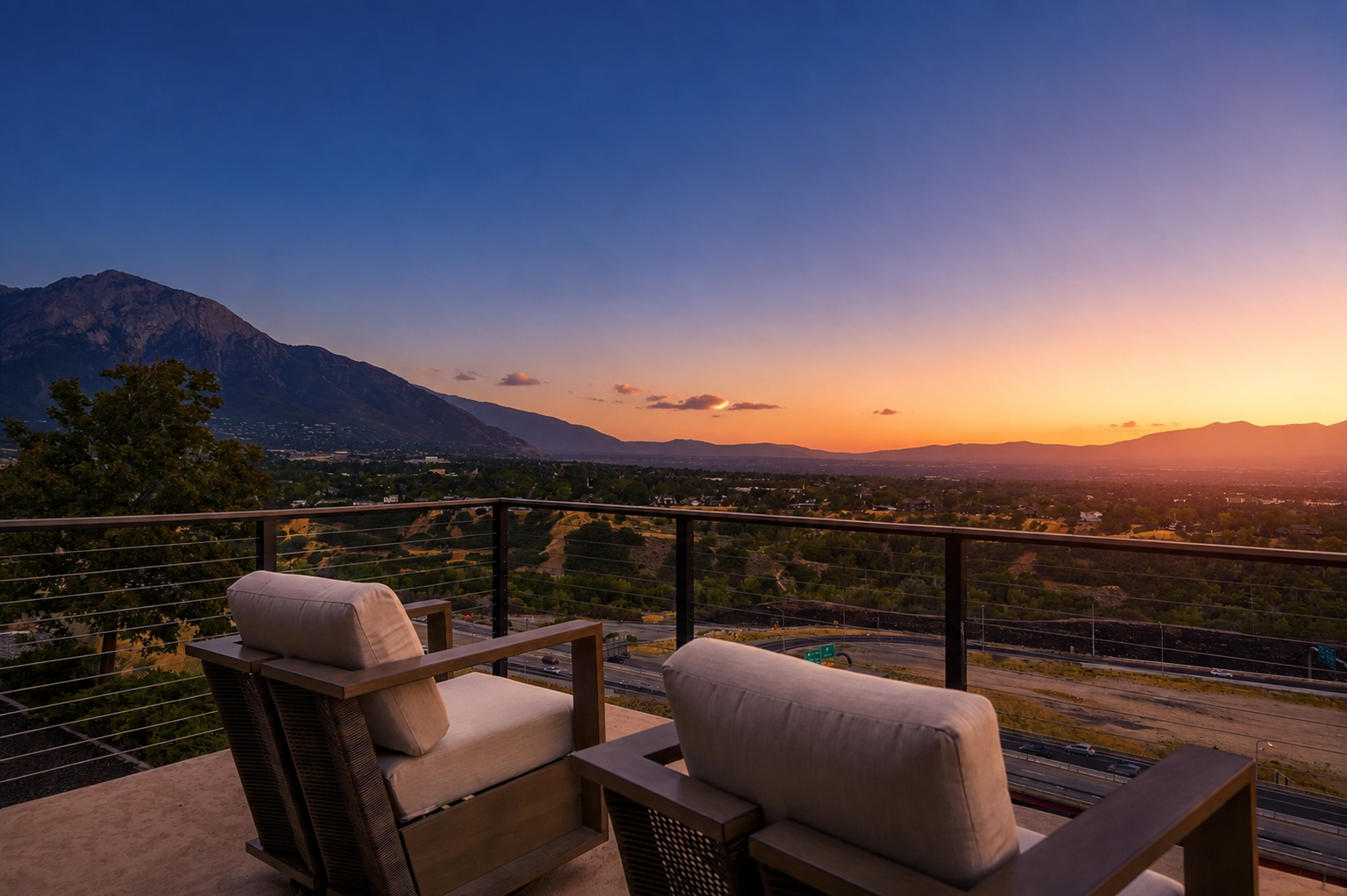 Two lounge chairs on a terrace at sunset